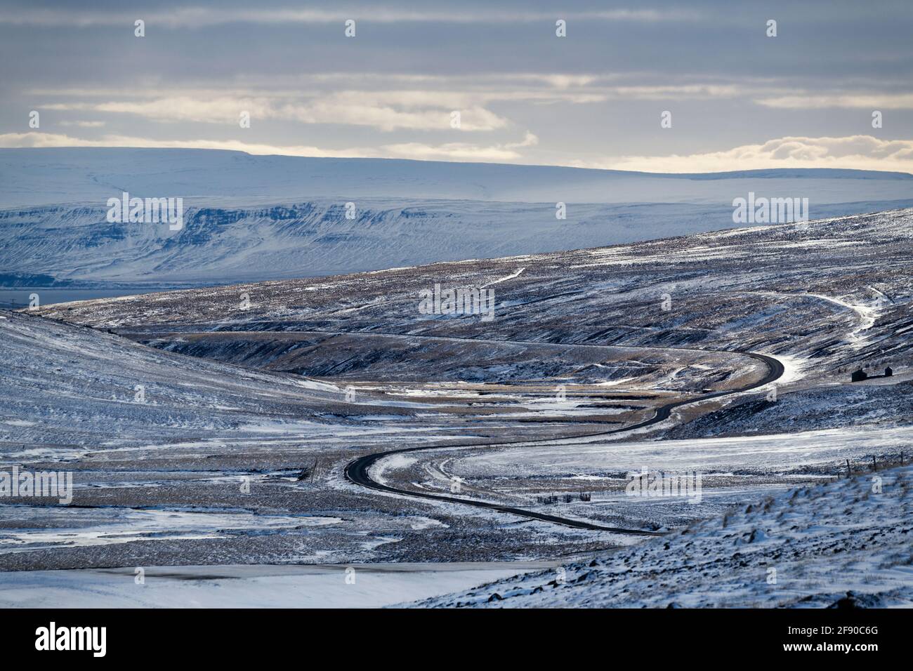 Winter landscape with winding road, Sandafell, Iceland Stock Photo