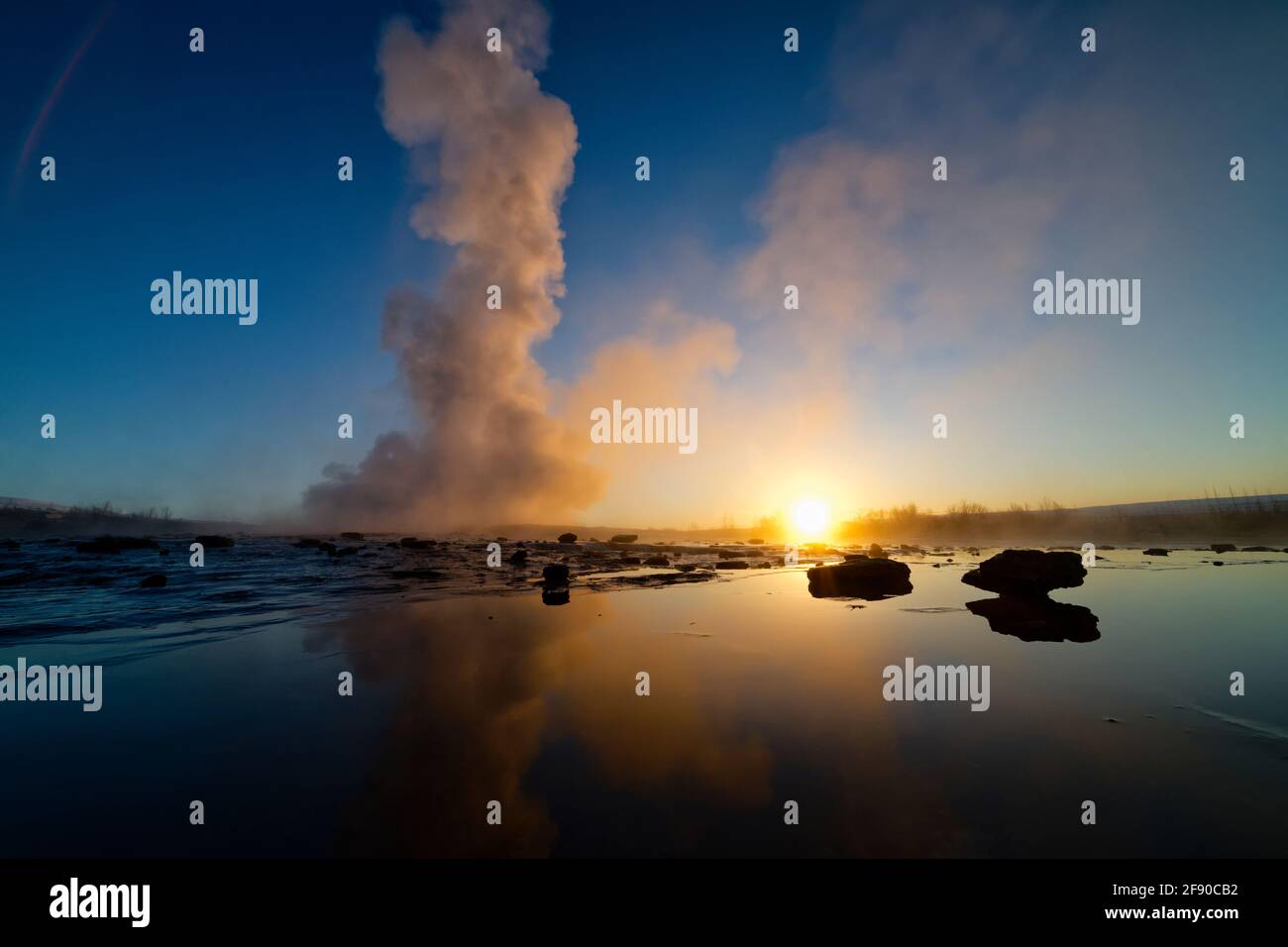 Steam above geyser at sunset, Iceland Stock Photo