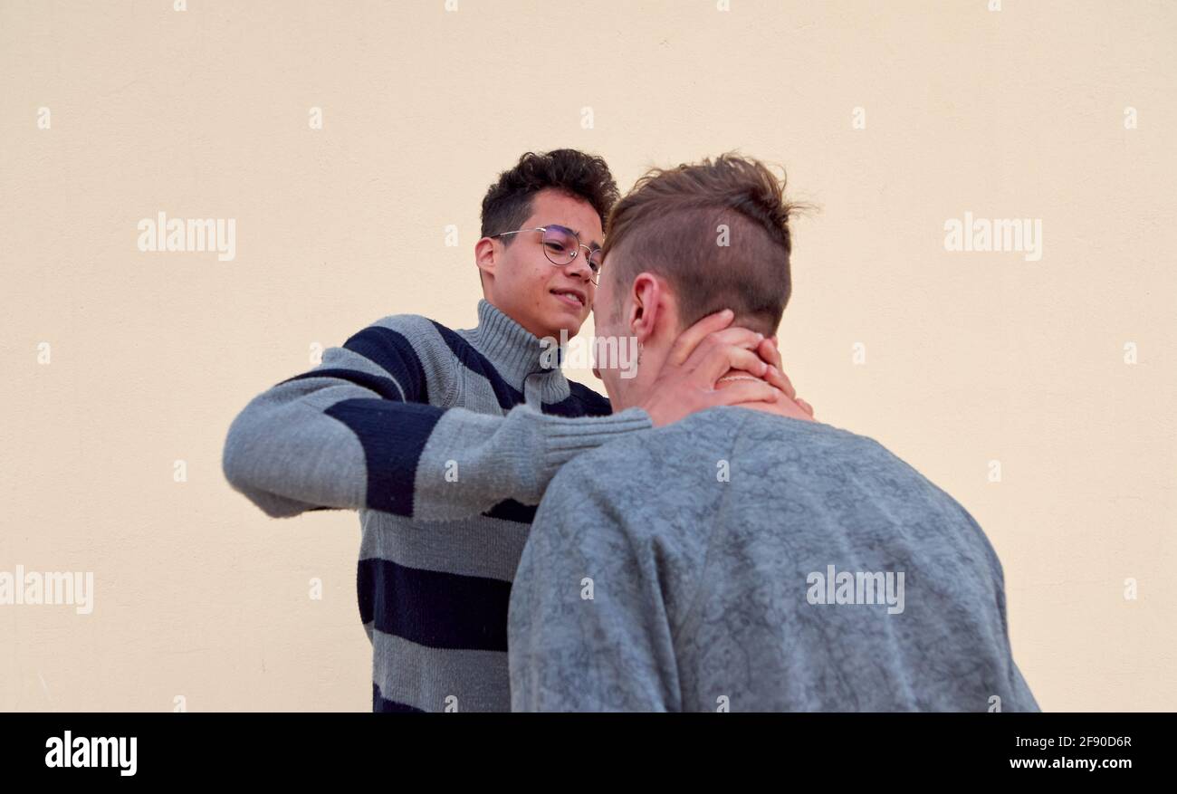 Young male agressively bully choking another male Stock Photo
