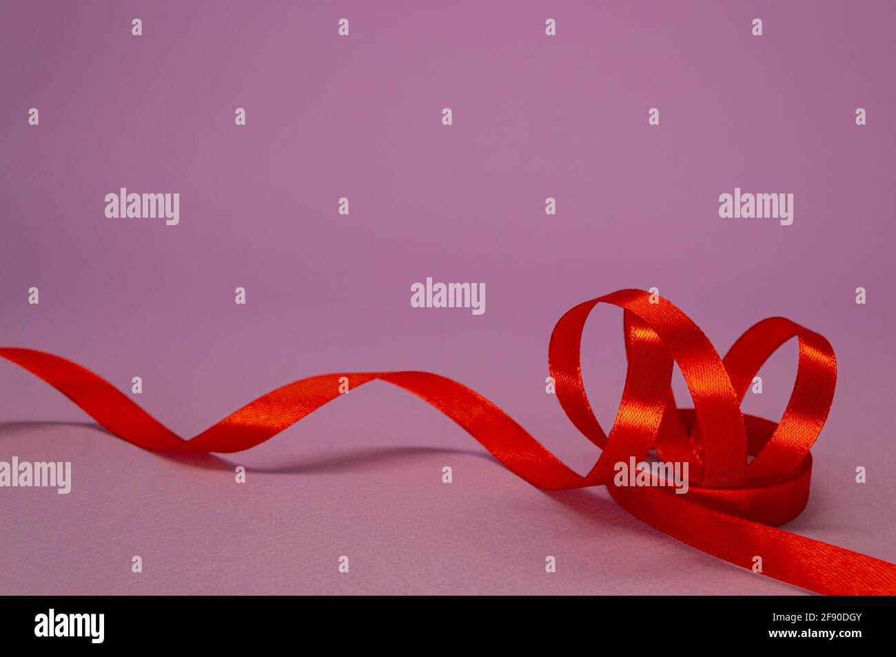 Red silk ribbon for wrapping gifts on white background. Curls of decorative  holiday ribbon. Element for design Stock Photo - Alamy