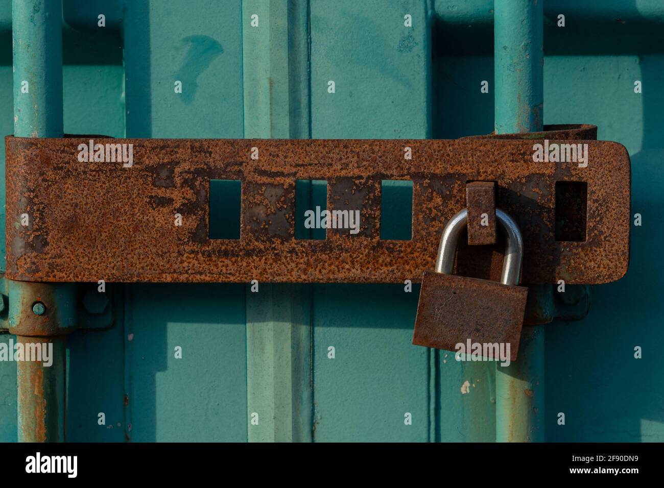 Closeup shot of an old metal lock on a green door Stock Photo - Alamy