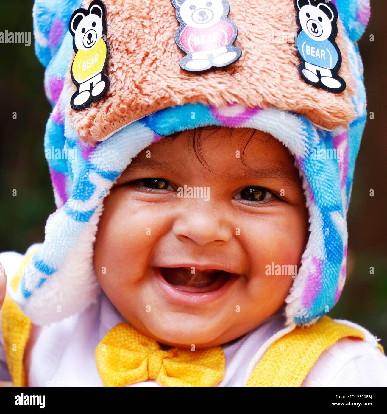 eight months age indian baby boy wearing fancy cloth cap with cute