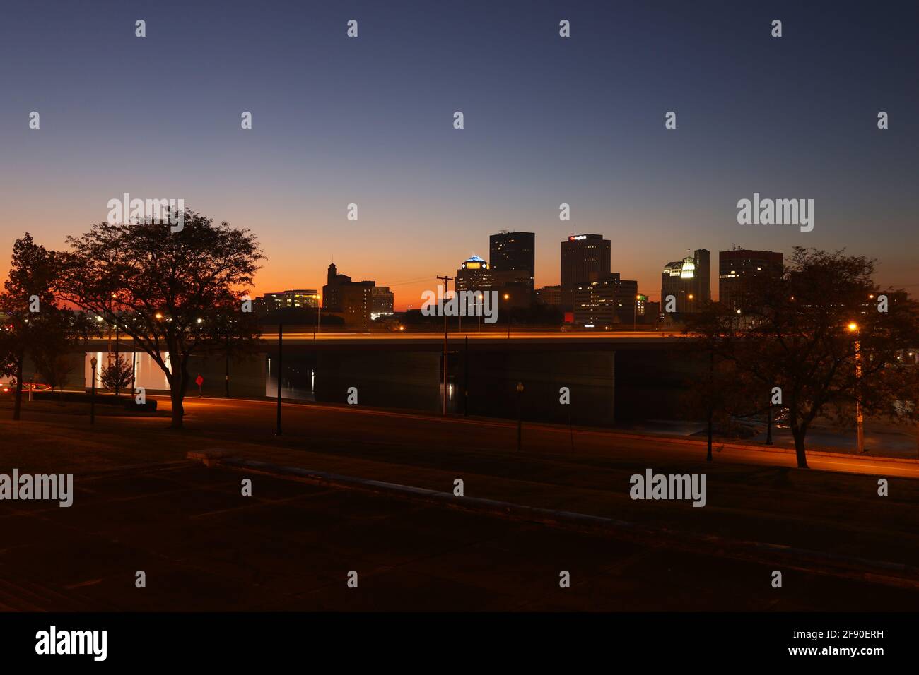 Dayton silhouette at morning twilight. Viewed from the steps of the Masonic Temple. Vehicle light trails are visible on Interstate 75 bridge. Dayton, Stock Photo