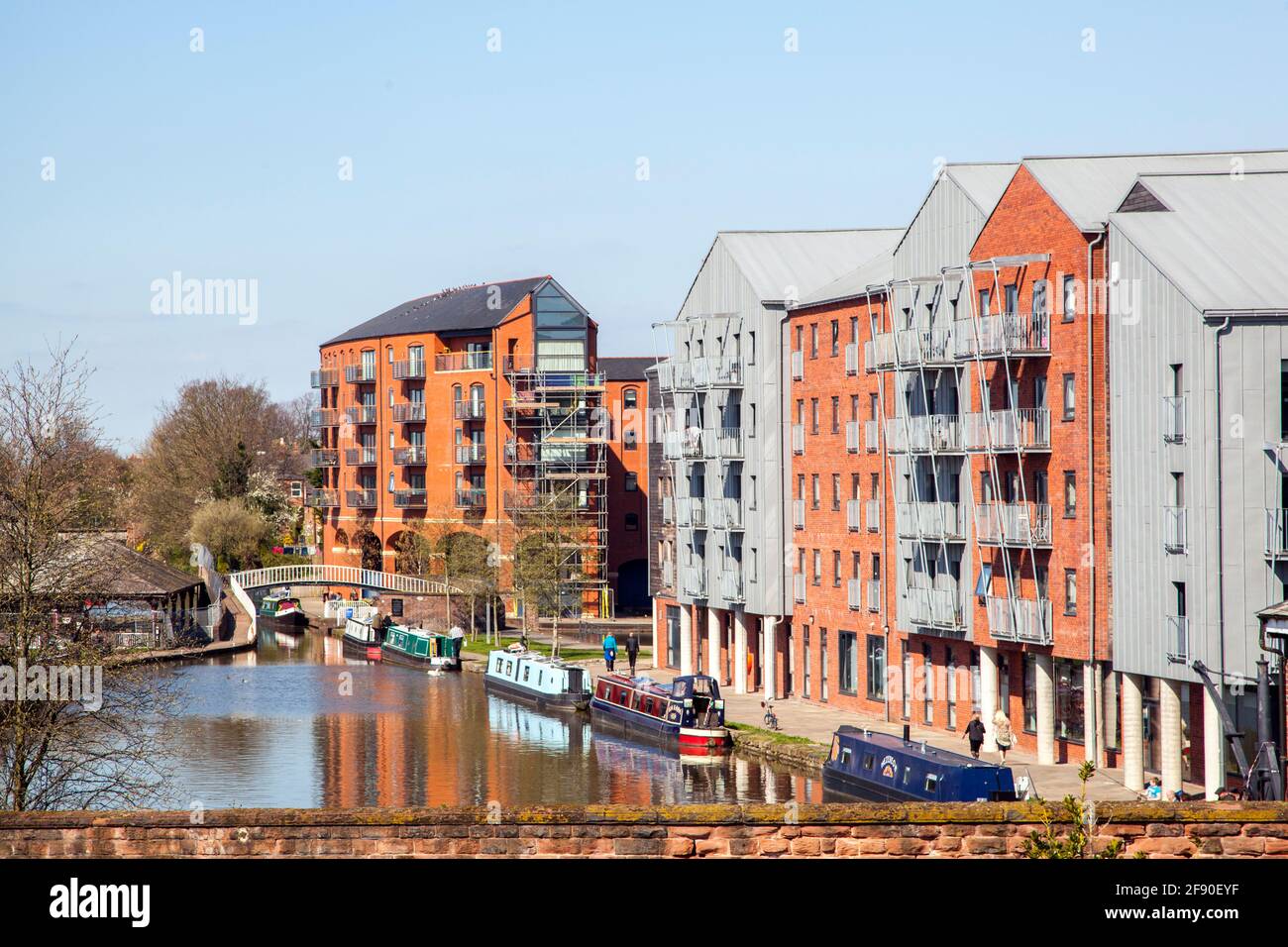 Canal side apartments and narrowboats on the Shropshire union canal as it passes through the Cheshire city of Chester England Stock Photo