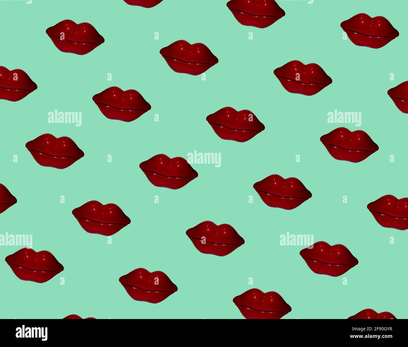 Dark red lips multiplied on soft green background. Minimal abstract pattern composition. Valentines, love, sending kisses idea. Stock Photo