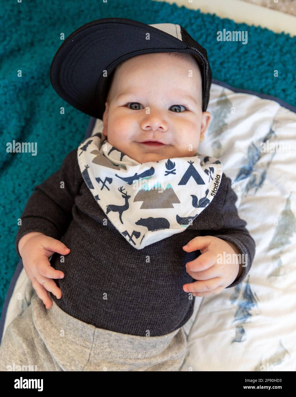Happy baby boy smiling wearing baseball cap. Stock Photo