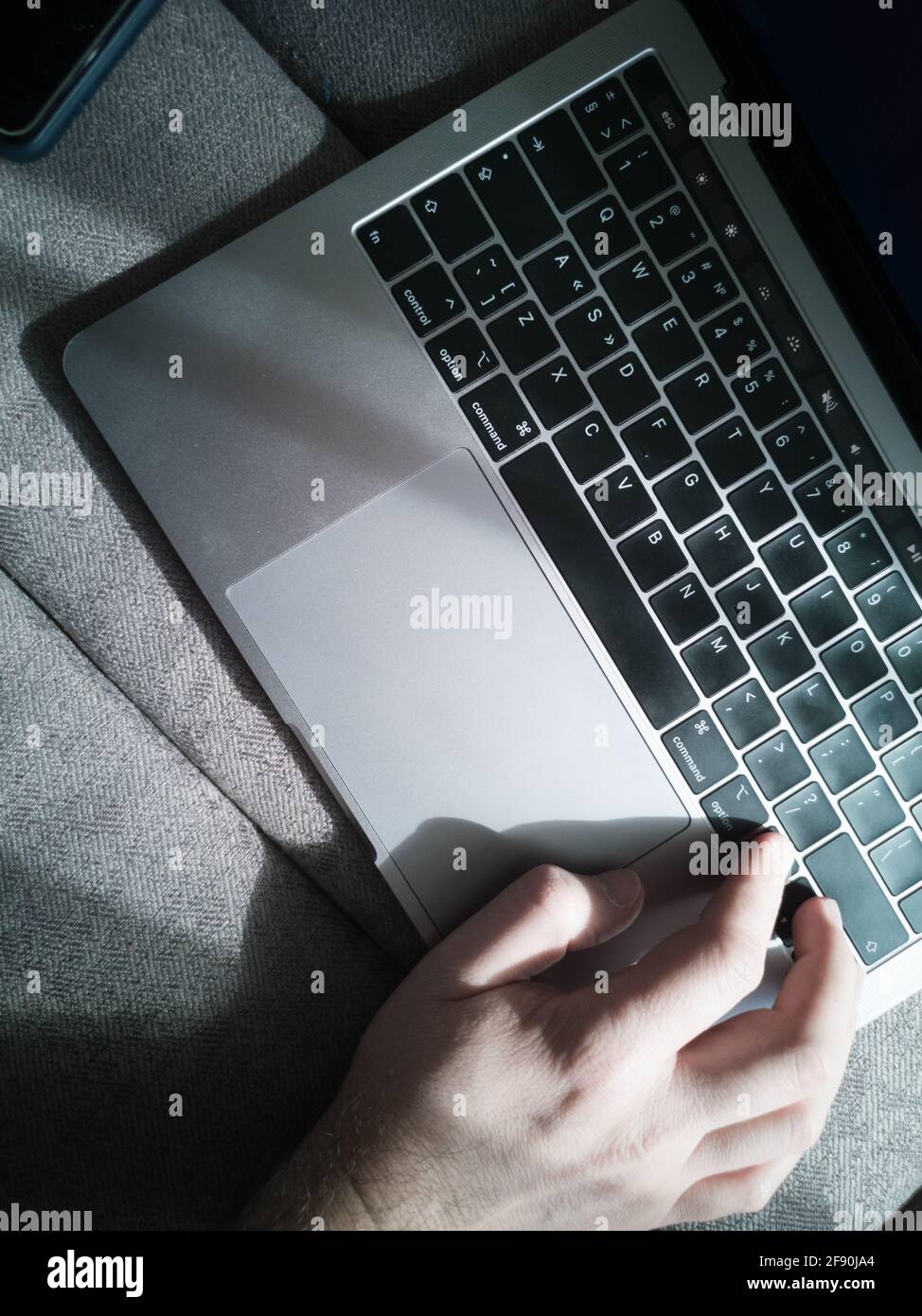 Man's hand on the laptop keyboard. Top view. Stock Photo