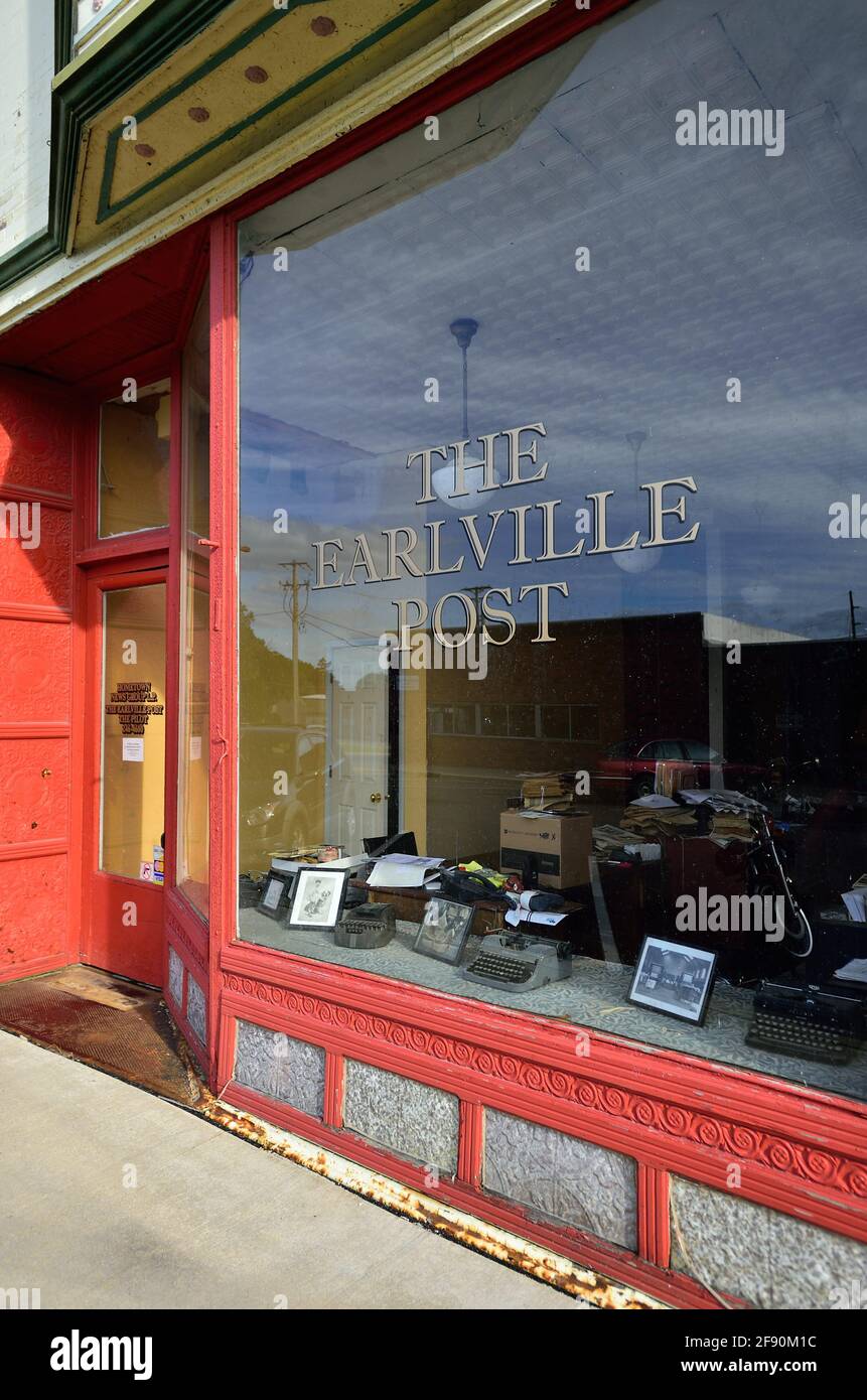 Earlville, Illinois, USA. The weekly community newspaper office complete with antique, museum-like display in the front widow of the venerable office. Stock Photo