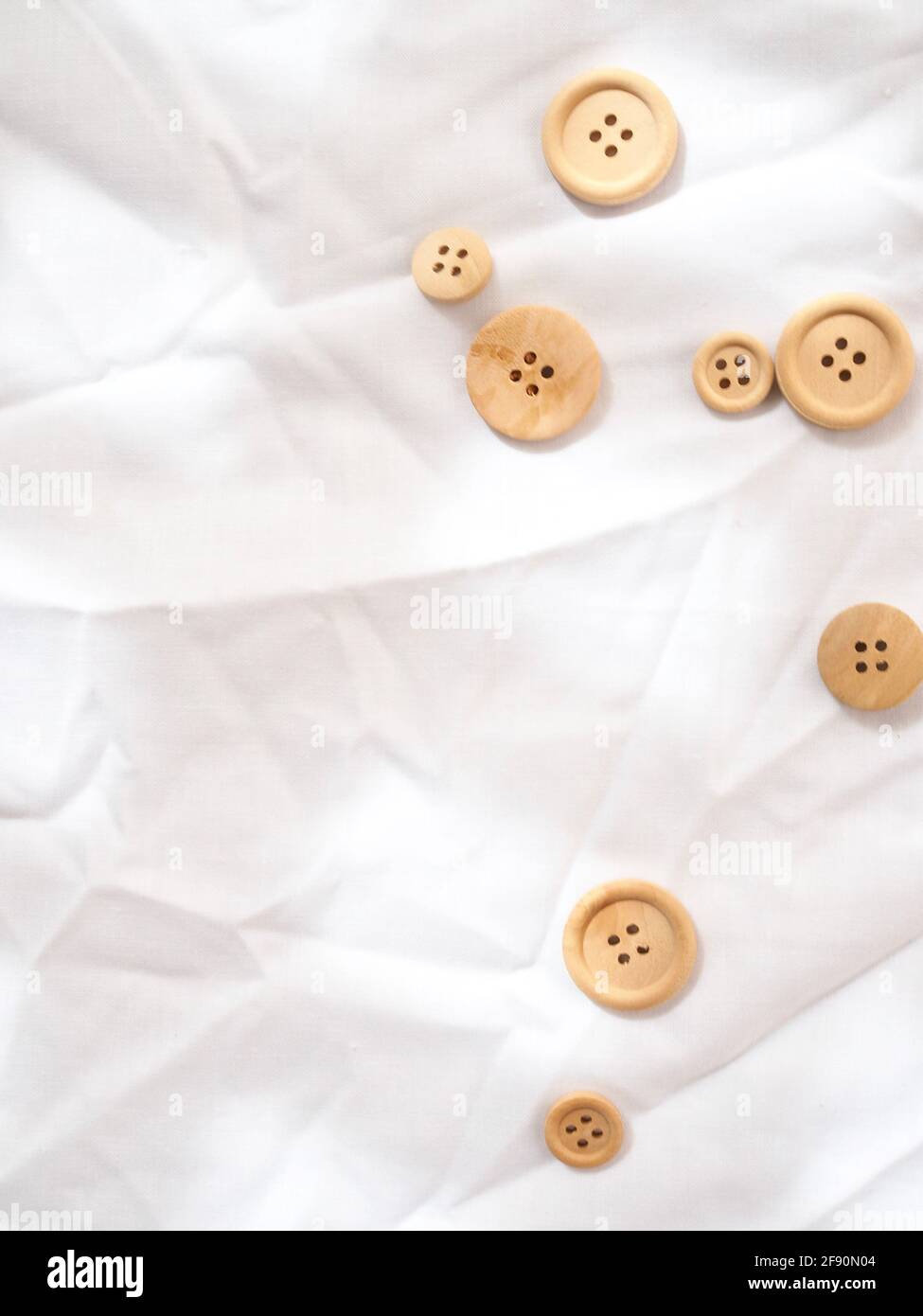 Simple wooden buttons on a white bright textured background Stock Photo ...