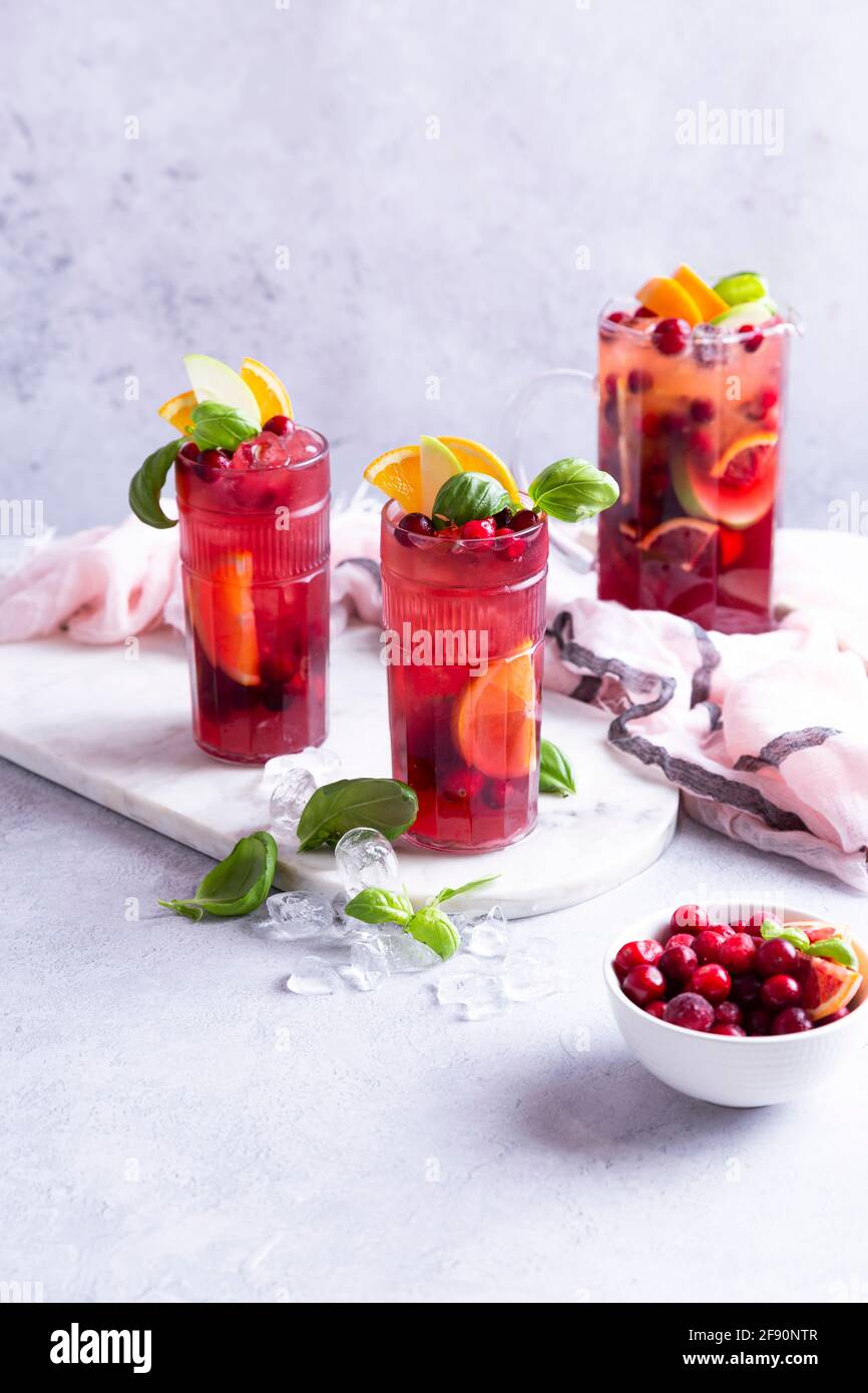 Fruit cocktail with apples, cranberries, oranges and basil Stock Photo
