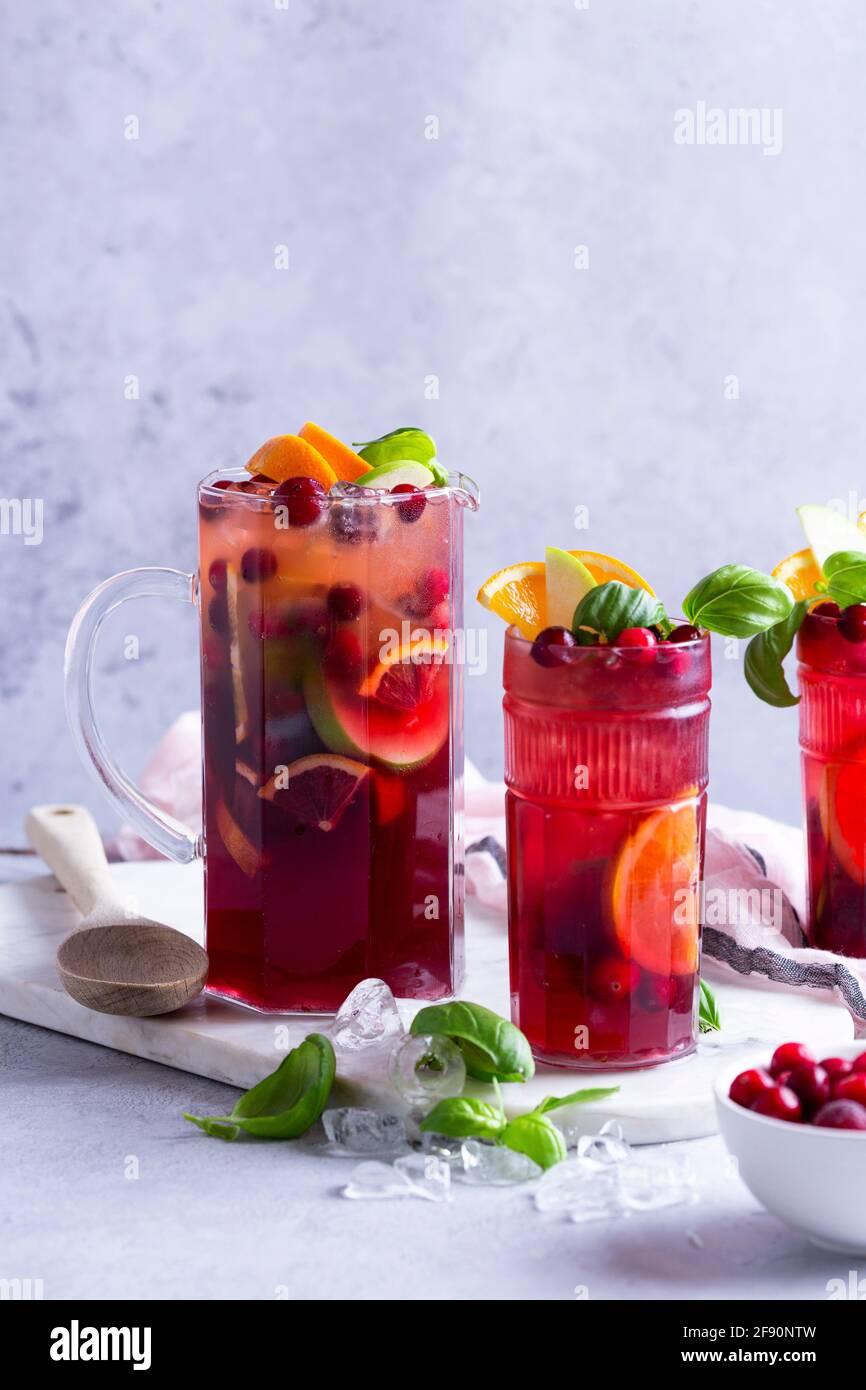 Fruit cocktail with apples, cranberries, oranges and basil Stock Photo