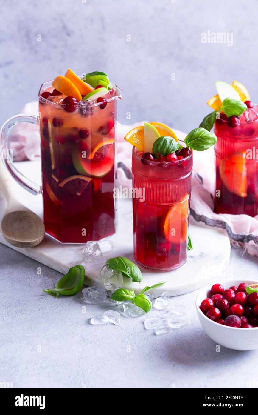 Fruit cocktail with apples, cranberries, oranges and basil Stock Photo