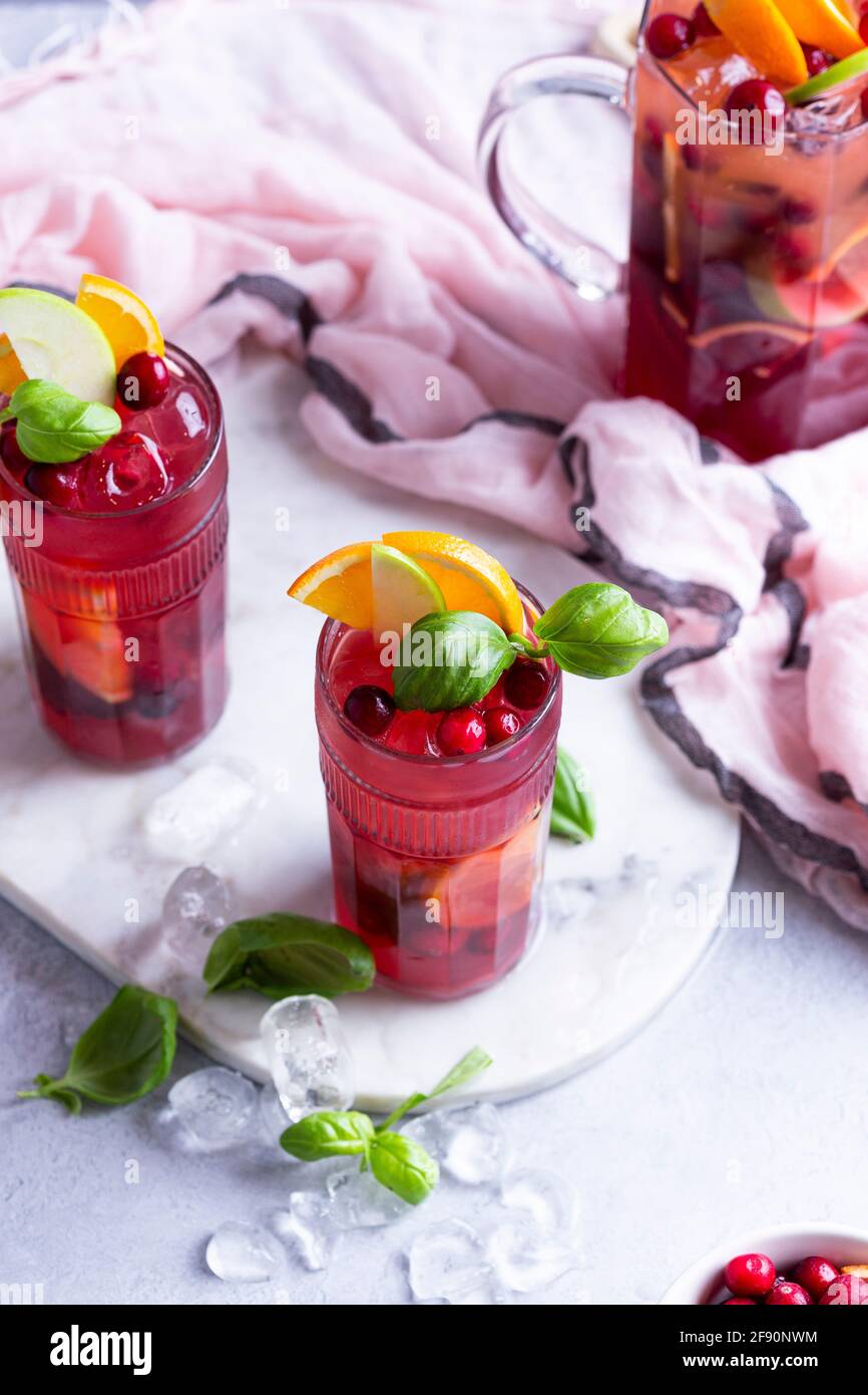 Fruit cocktail with apples, cranberries, oranges and basil Stock Photo