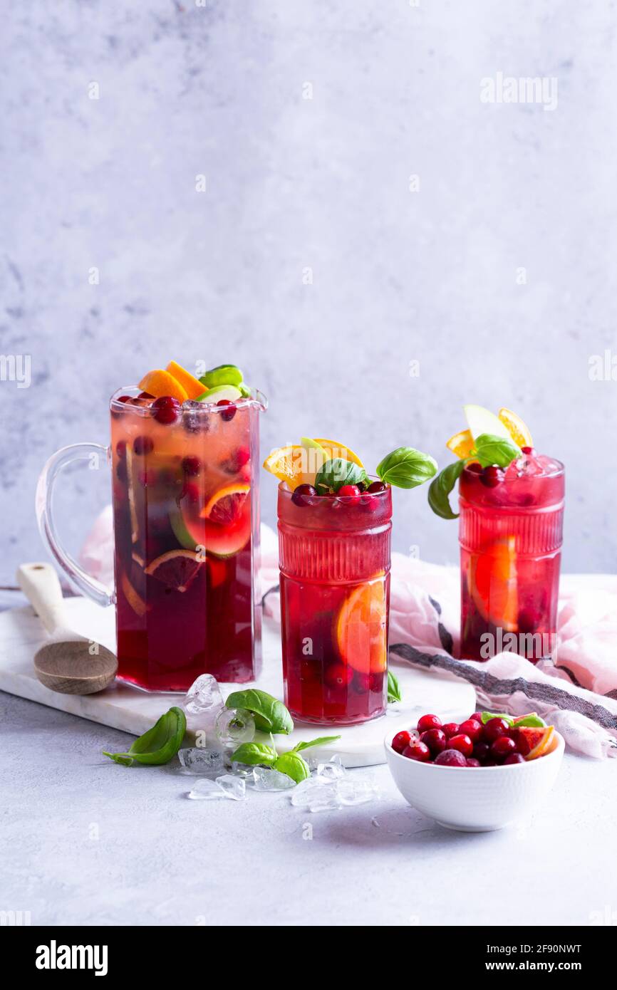 Fruit cocktail with apples, cranberries, oranges and basil Stock Photo