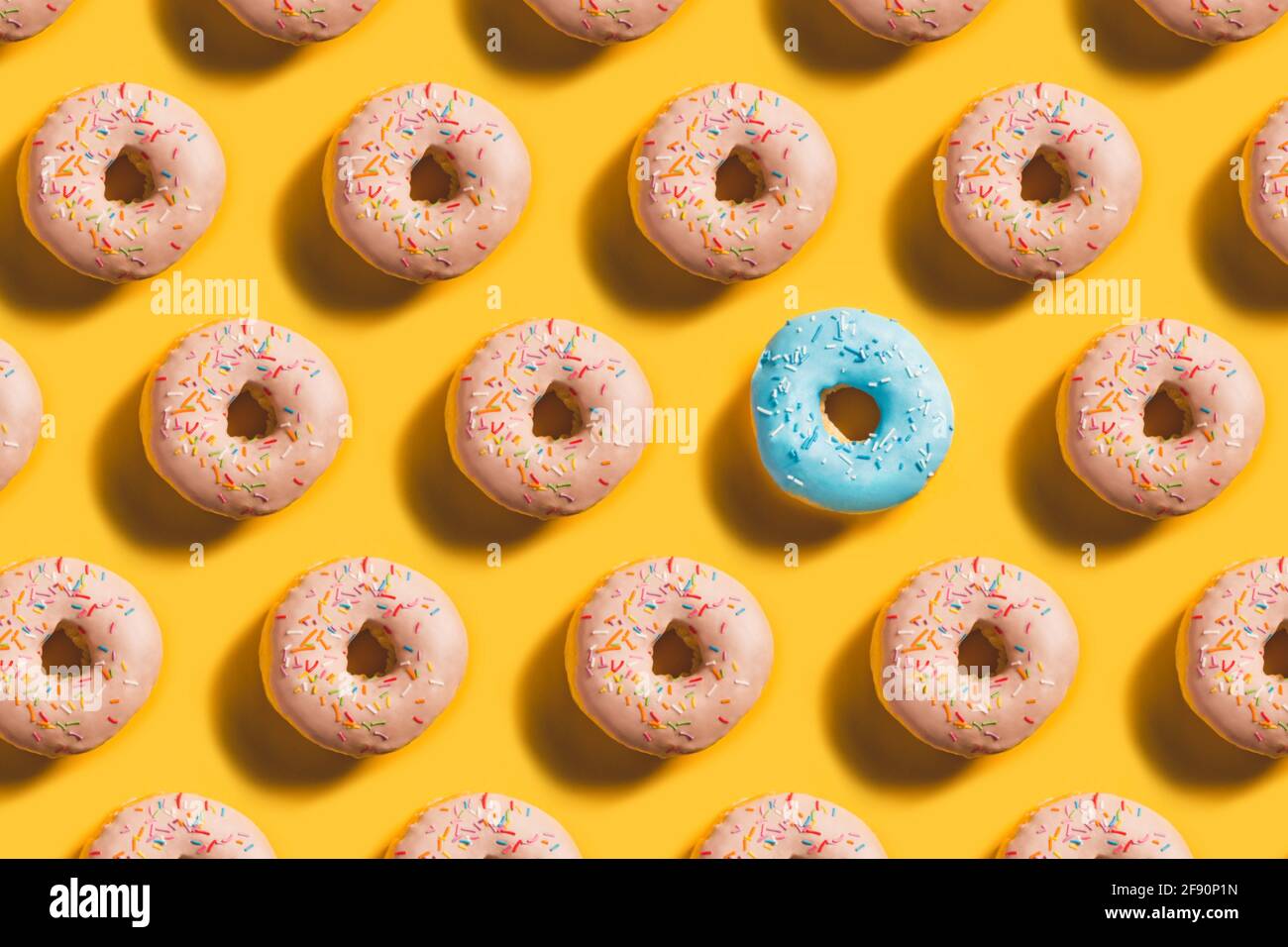Doughnut Pattern with blue accent on yellow background Stock Photo