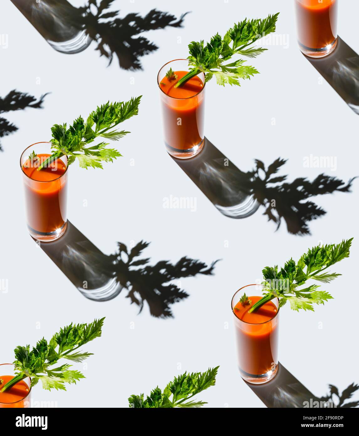 Carrot juice with celery on gray background Pattern Stock Photo