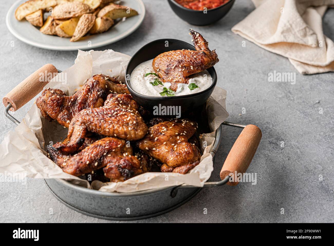 Chicken wings with dips and potatoes Stock Photo Alamy