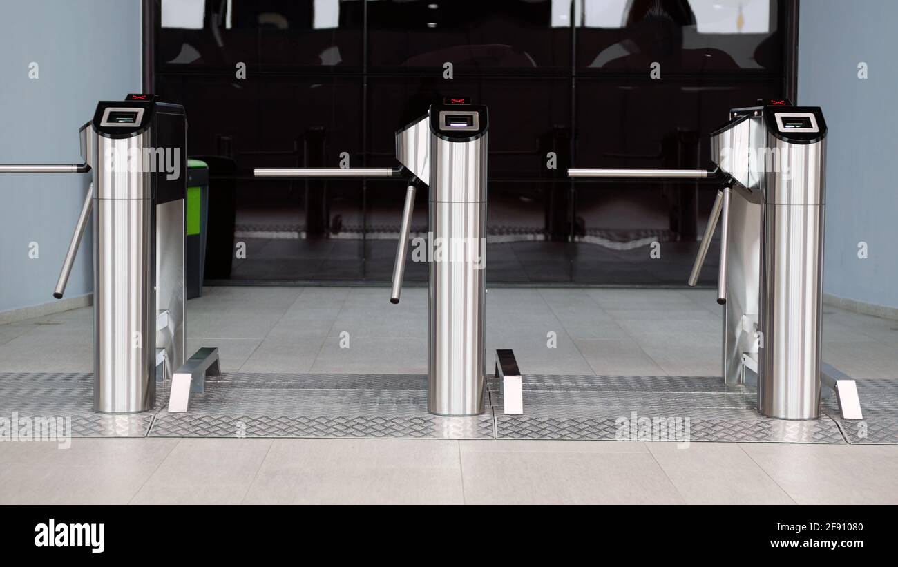 Turnstile for admitting visitors to the trading floor in front of the entrance. Stock Photo