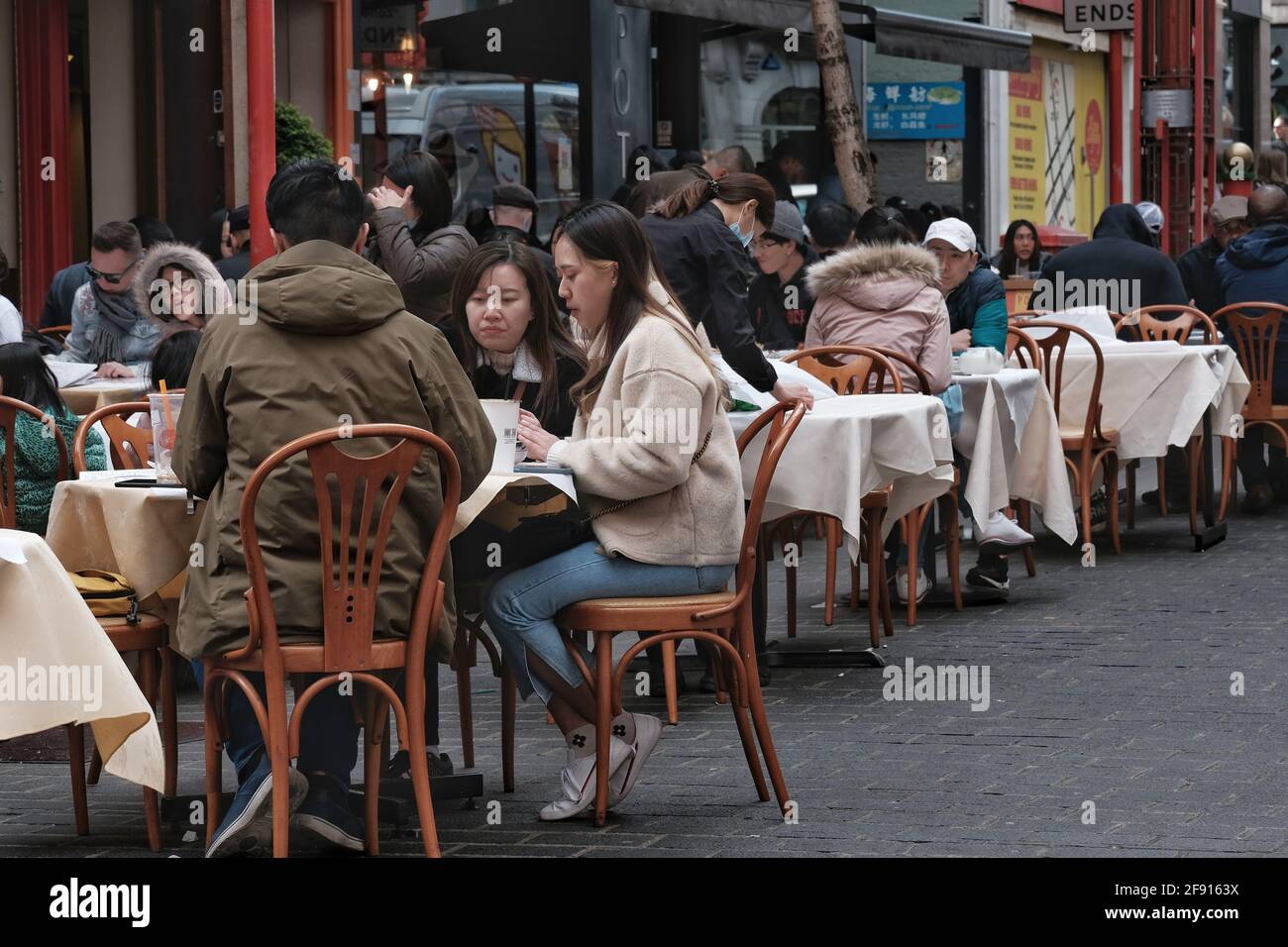 Diners in London's Chinatown enjoy a meal out on the first day outdoor hospitality returns as Covid restrictions are further eased in England Stock Photo