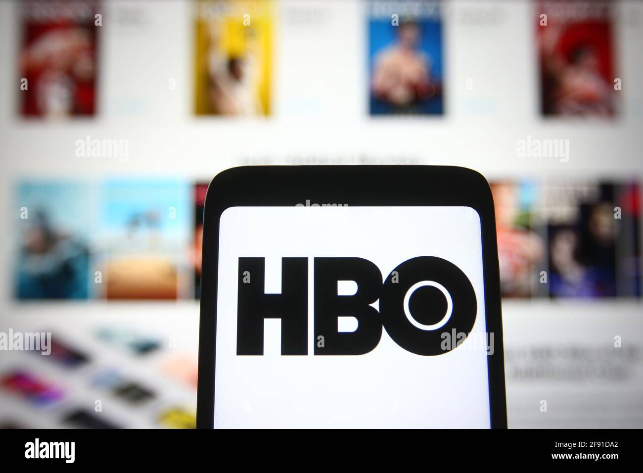In this photo illustration a HBO (Home Box Office) logo is seen on a  smartphone screen with its website in the background Stock Photo - Alamy