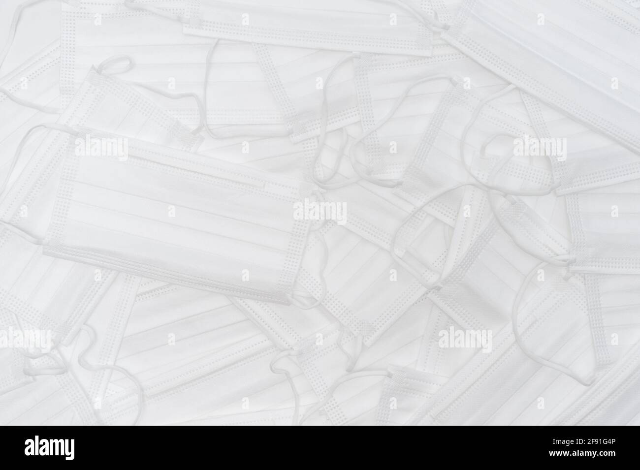 White surgical masks scattered. Top view Stock Photo - Alamy