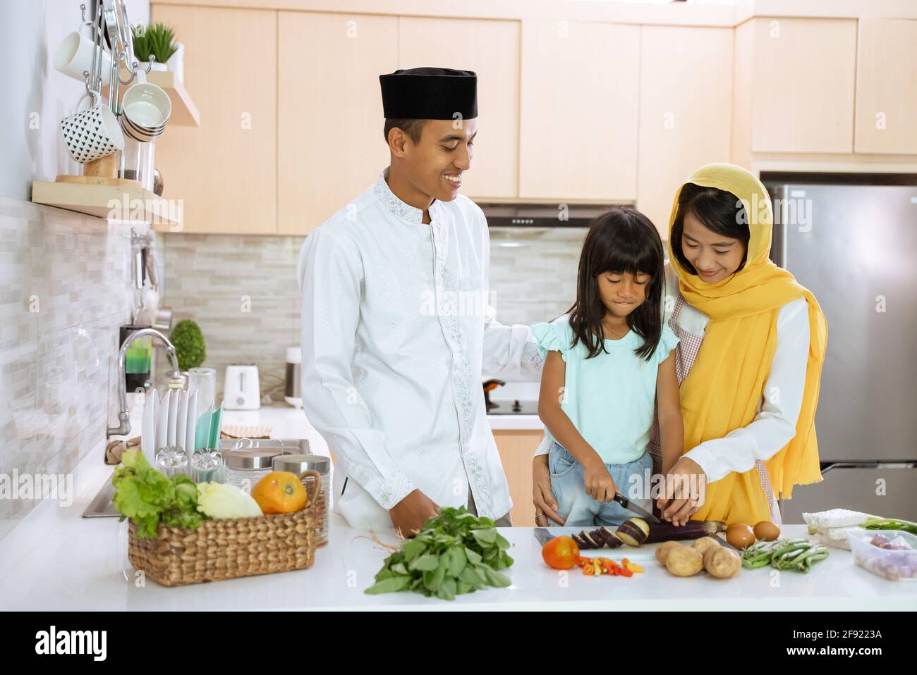 muslim parent and kid cooking and preparing for iftar dinner on ramadan Stock Photo