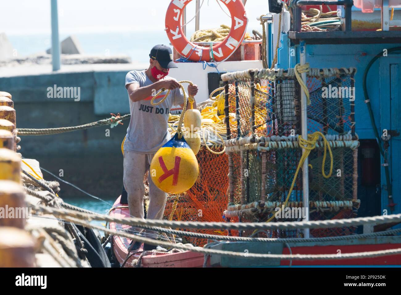 South African fisherman working on a fishing boat in Kalk Bay harbour concept fishing industry South Africa Stock Photo