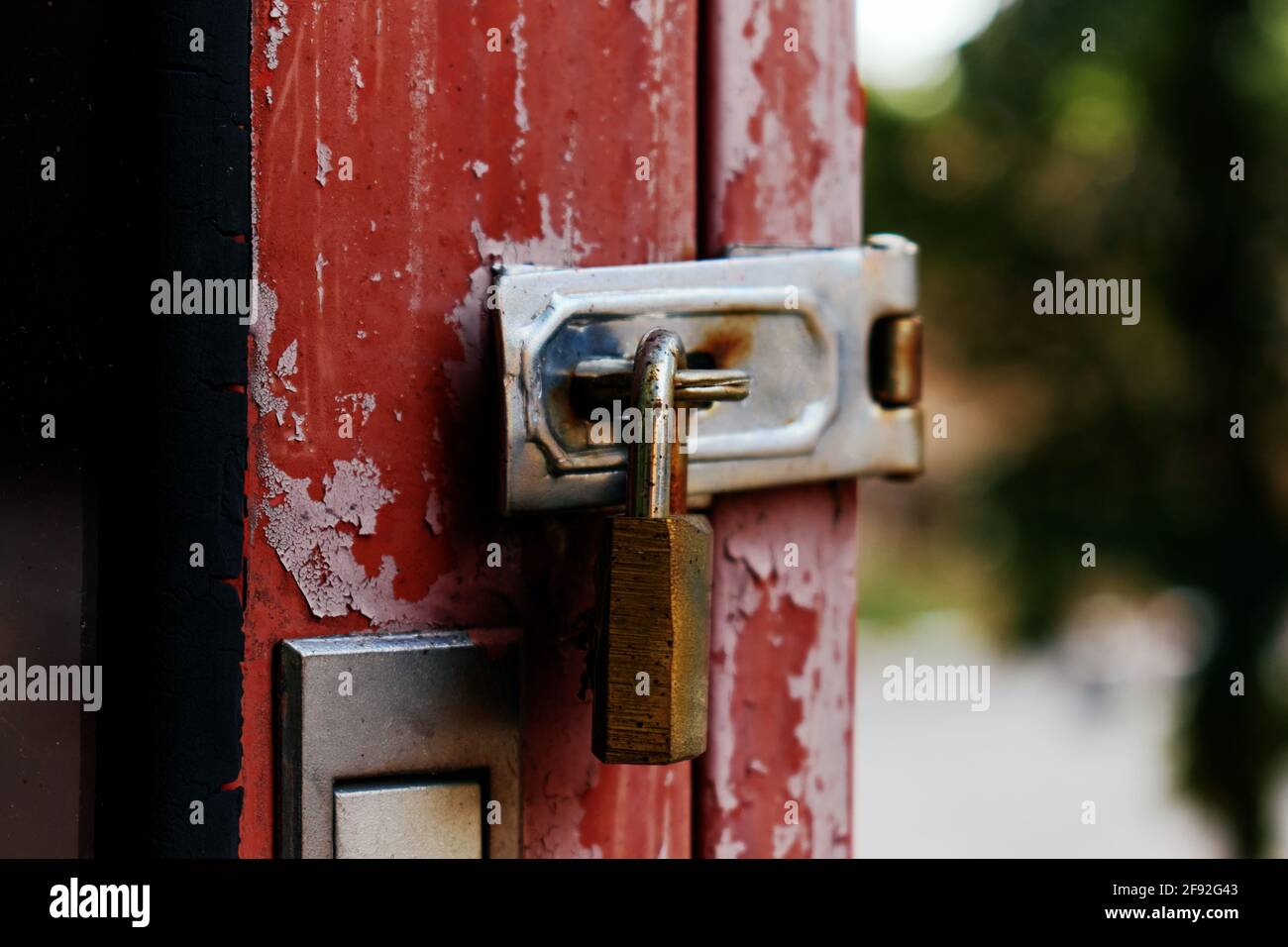 The old rusty padlock on the red door Stock Photo