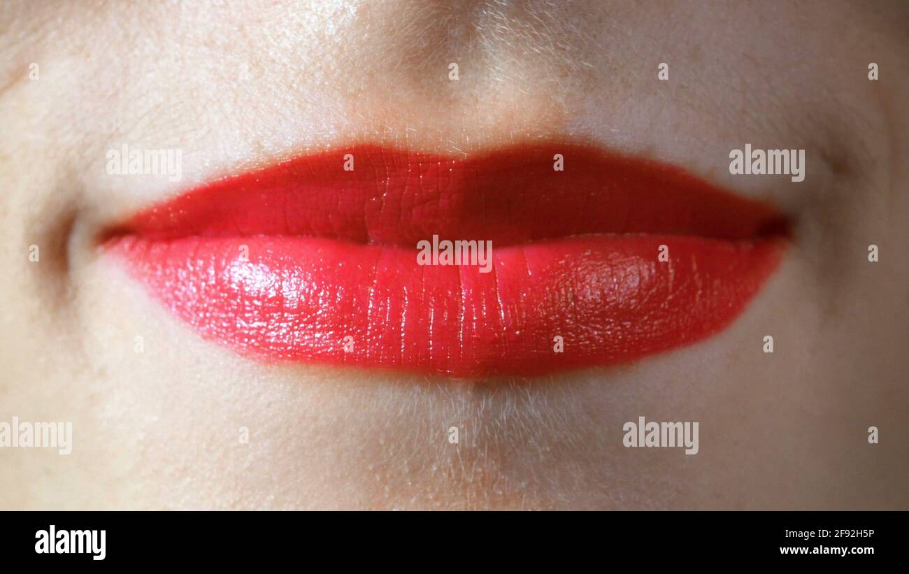 Closeup photo of red attractive smiling lips Stock Photo