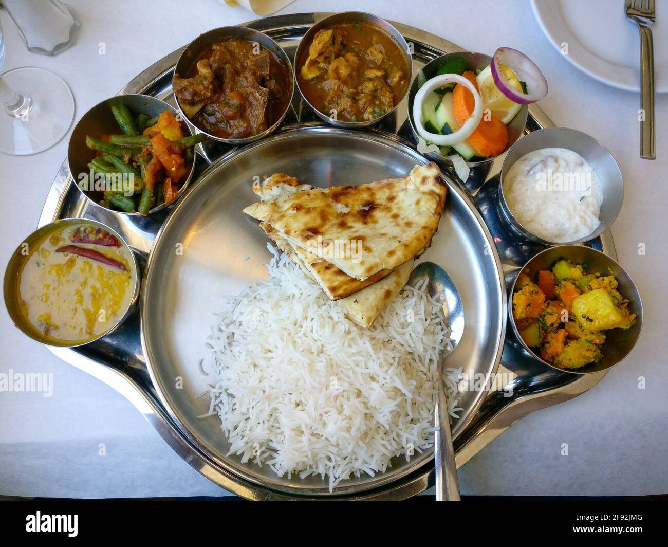 Top view of a Nepalese meal plate - bread, rice and side servings Stock ...