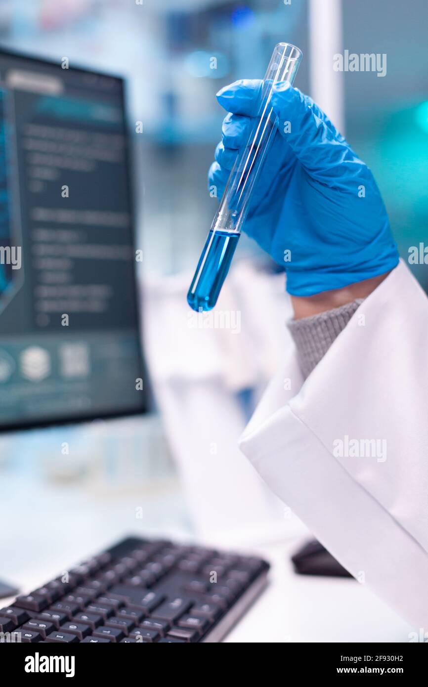 Close up of test tubes for science experiment. Doctor in white coat ...
