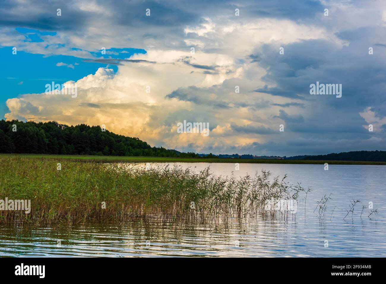beautiful waterscape on a lake and dramatic gloomy and cloudy sky at evening. beauty in nature. horizontal photo Stock Photo