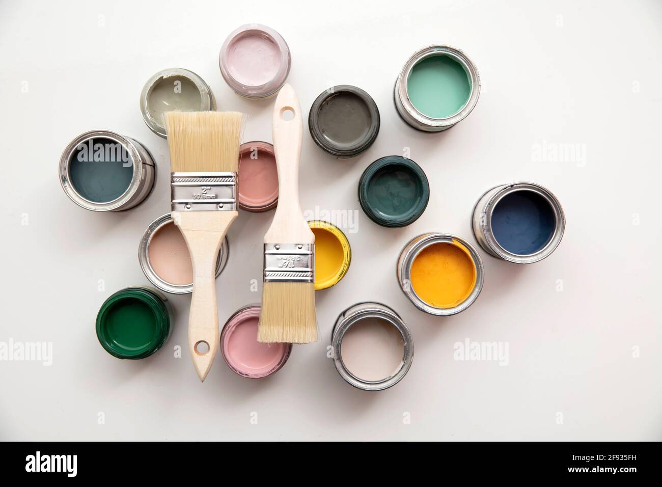 Overhead view of a DIY paint brush with colorful sample paint pots