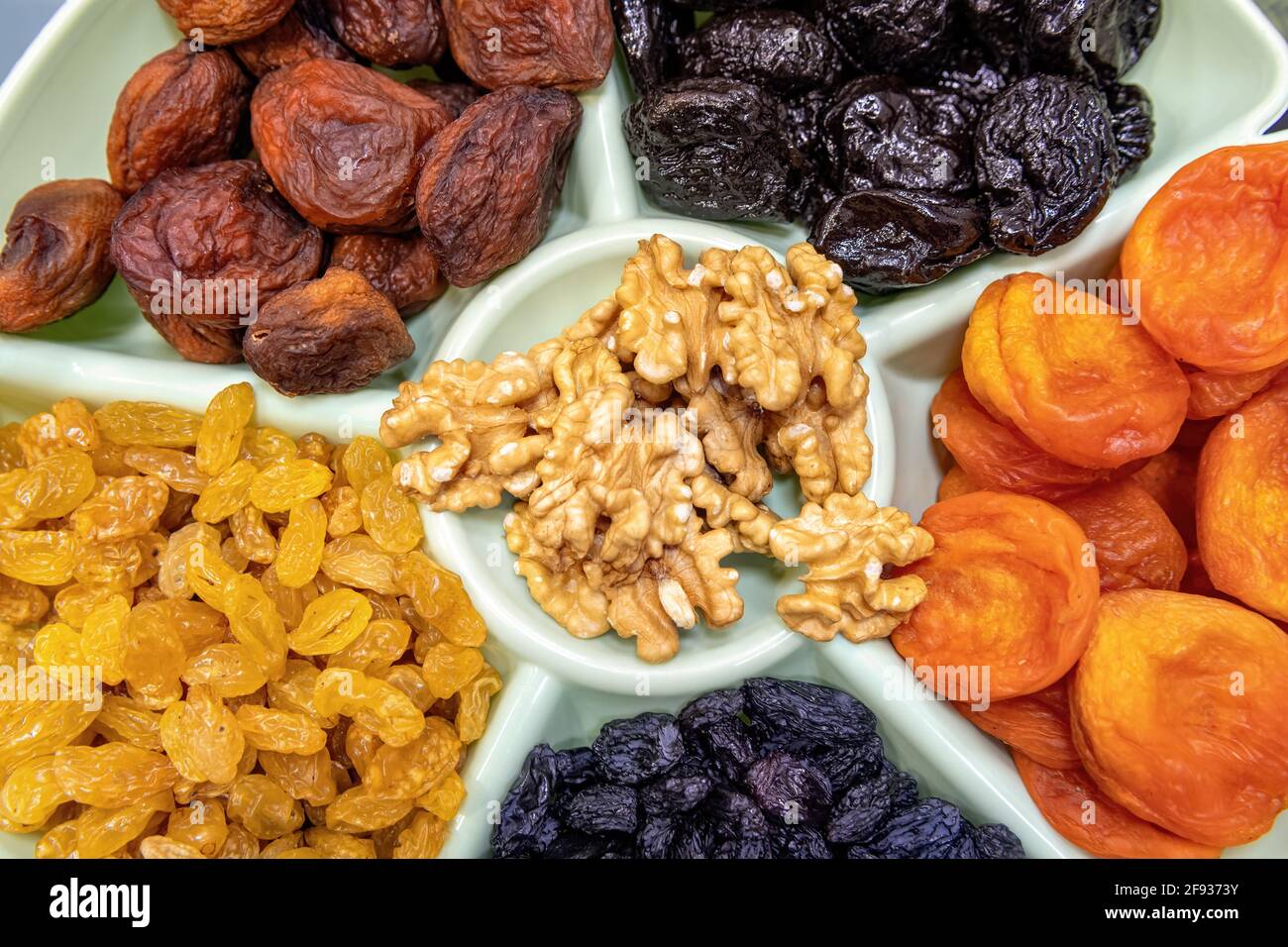 Dried fruits and nuts top view. Dried apricots, raisins, prunes and ...