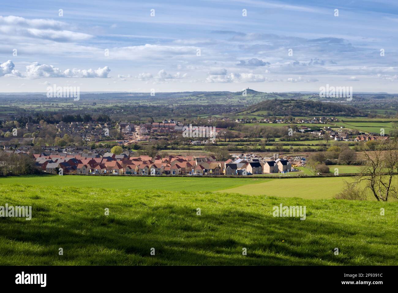 Large new housing estates being constructed on the outskirts of the City of Wells on the edge of the Mendip Hills, Somerset, England. Stock Photo