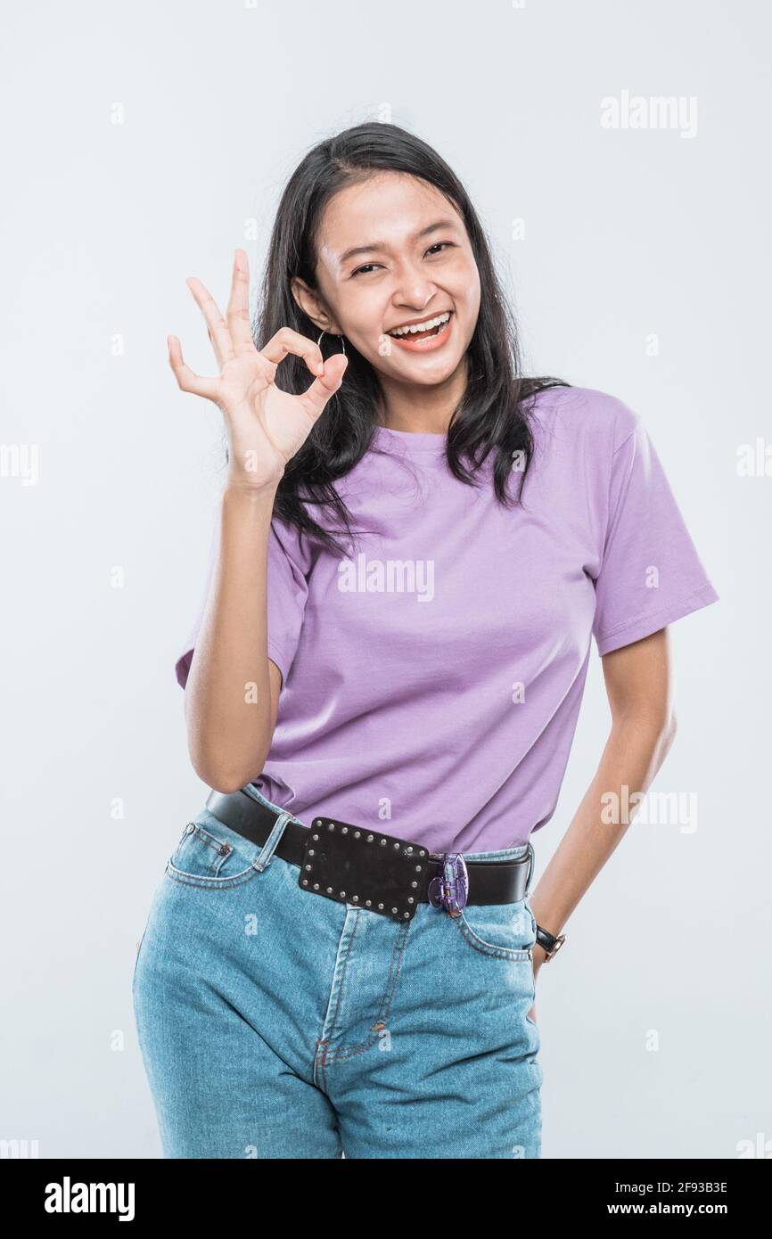 Beautiful young Asian woman raising hand and show OK sign Stock Photo ...