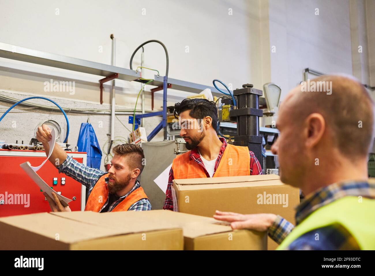 Warehouse workers team with cardboard boxes and checklist checks