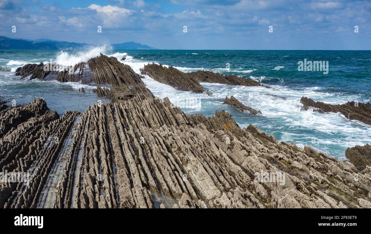 Zumaia, Spain - March 17, 2021: Flysch rock formations on the beach in Zumaia, Basque Country, Spain Stock Photo