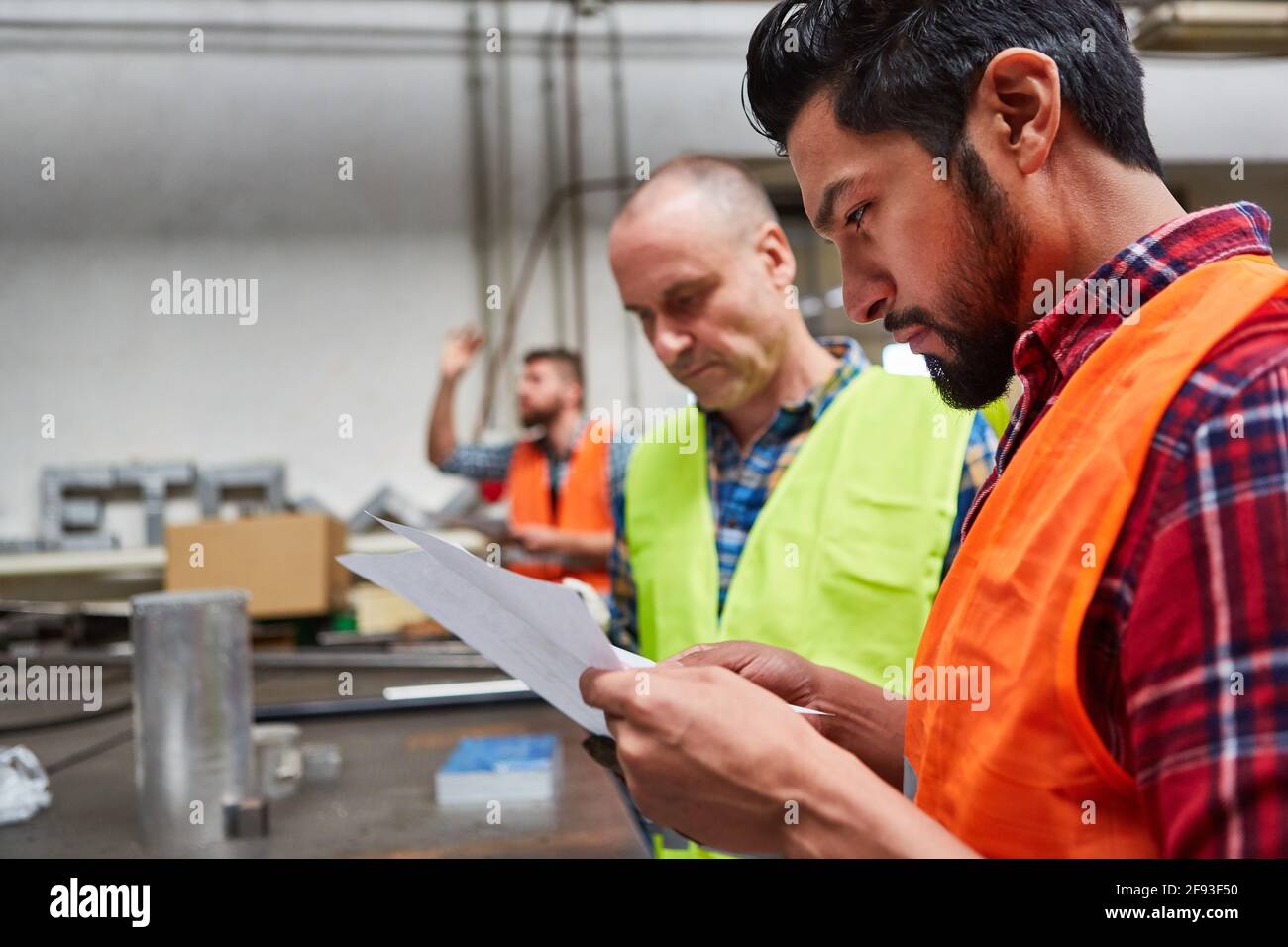 Two workers or craftsmen are planning an order or checking an order Stock Photo