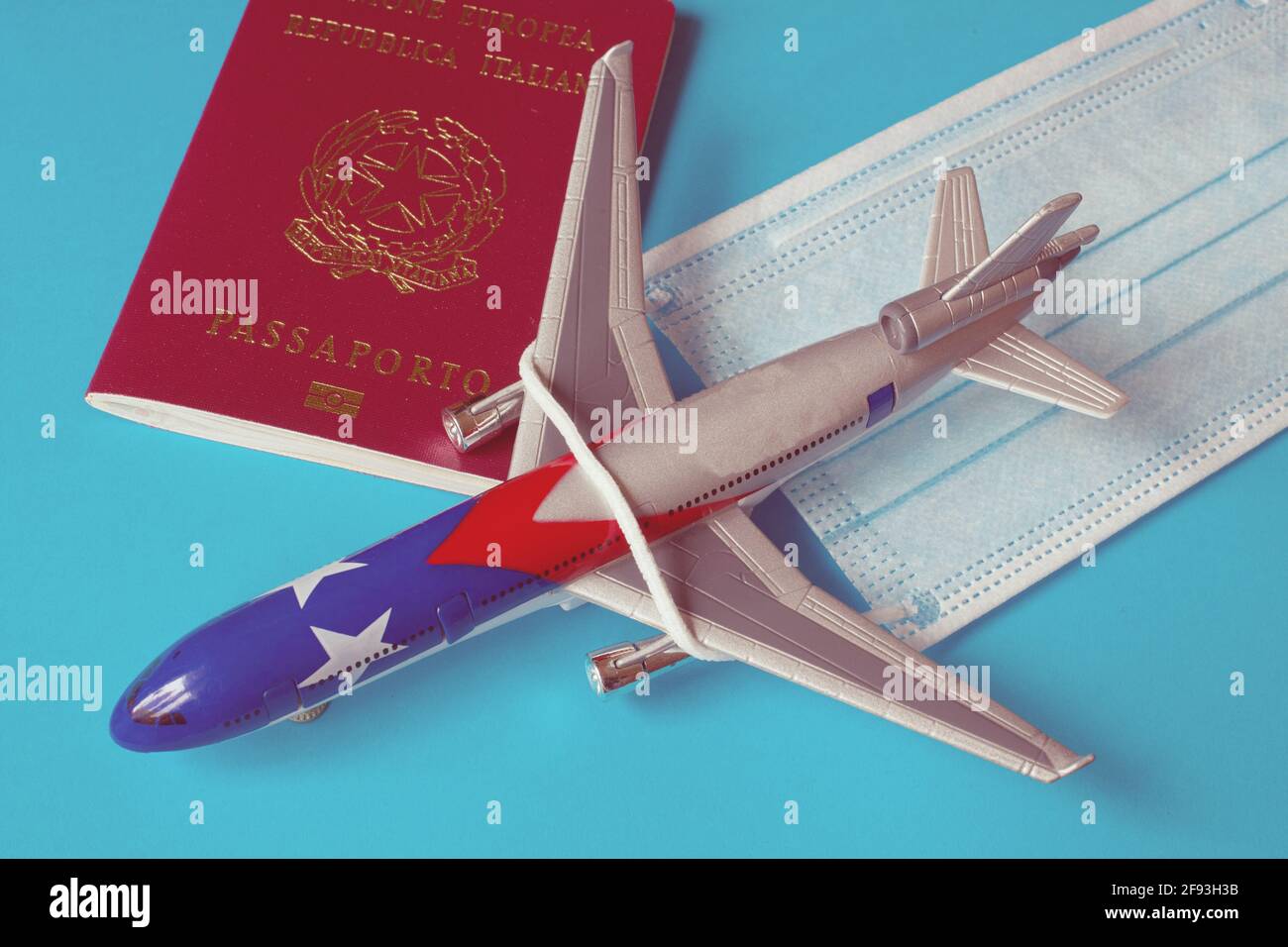 Plane with a facemask and a passport, concept of traveling safe Stock Photo