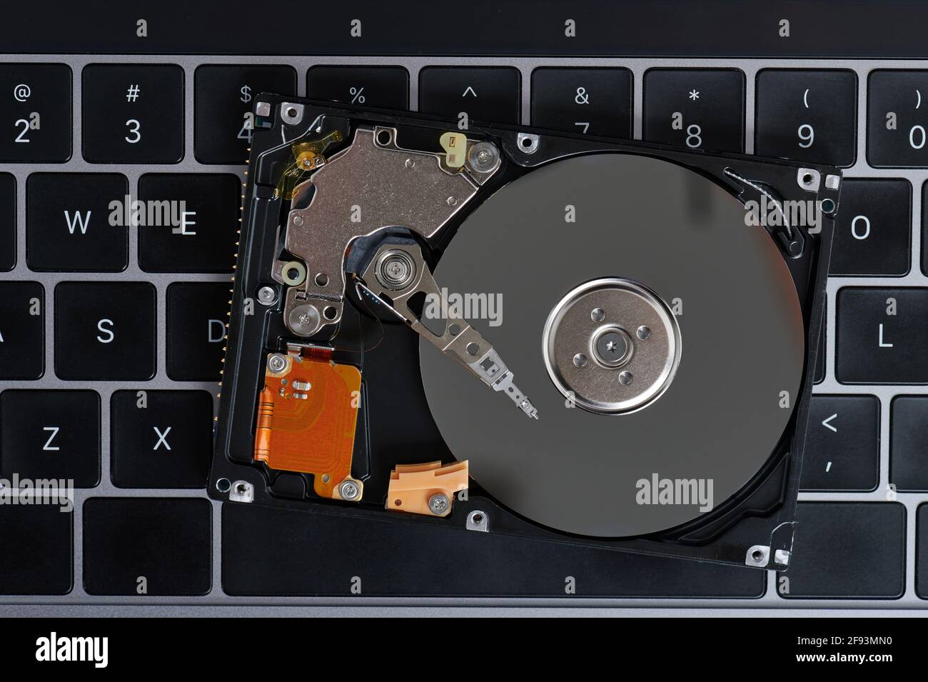 Reading data from hard drive on laptop keyboard background Stock Photo