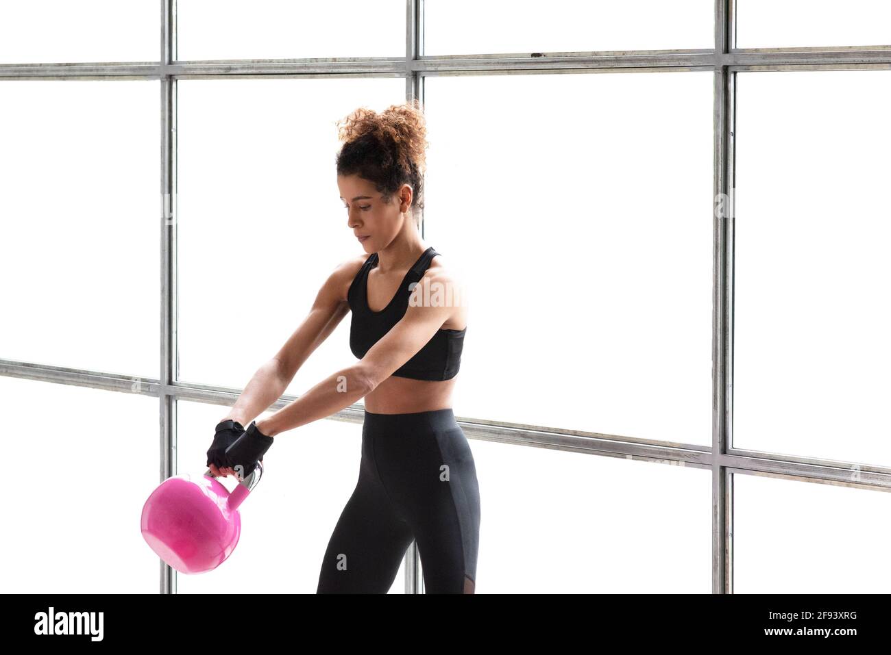 Royalty-Free photo: Close up photo of pink and black kettlebell and running  shoes