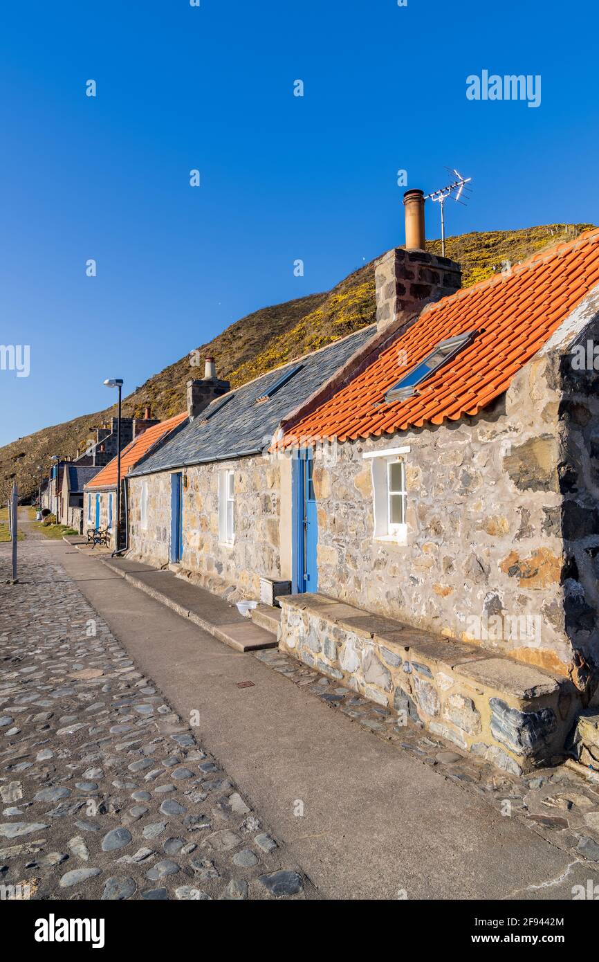 Crovie, Aberdeenshire, UK. 15th Apr, 2021. UK. This is the small old fishing village of Crovie which is directly on the shore. It was basking in the sun. Credit: JASPERIMAGE/Alamy Live News Stock Photo