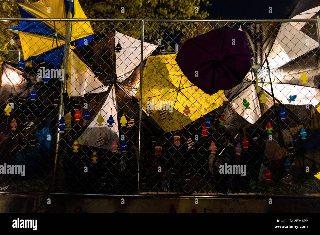 Air fresheners and umbrellas hang on the fence erected outside the Brooklyn Center police department in Brooklyn Center, Minnesota on April 15, 2021. The community is gathered after Brooklyn Center police officer Kim Potter shot and killed Duante Wright during a traffic stop. An air freshener hung on the rearview mirror of the car Duante was in was rumored to be one of the reasons he was stoped by police. His death was during the nearby trial of Derek Chauvin for the murder of George Floyd. (Photo by Brian Feinzimer/Sipa USA) Stock Photo