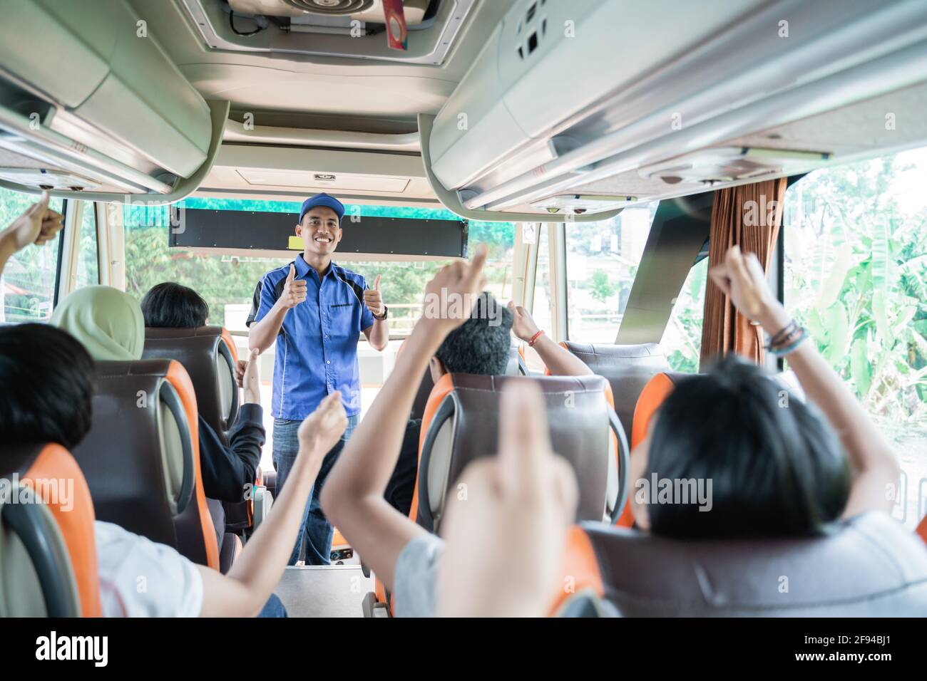 Male bus crew in blue uniform and hat with thumbs up when checking ...