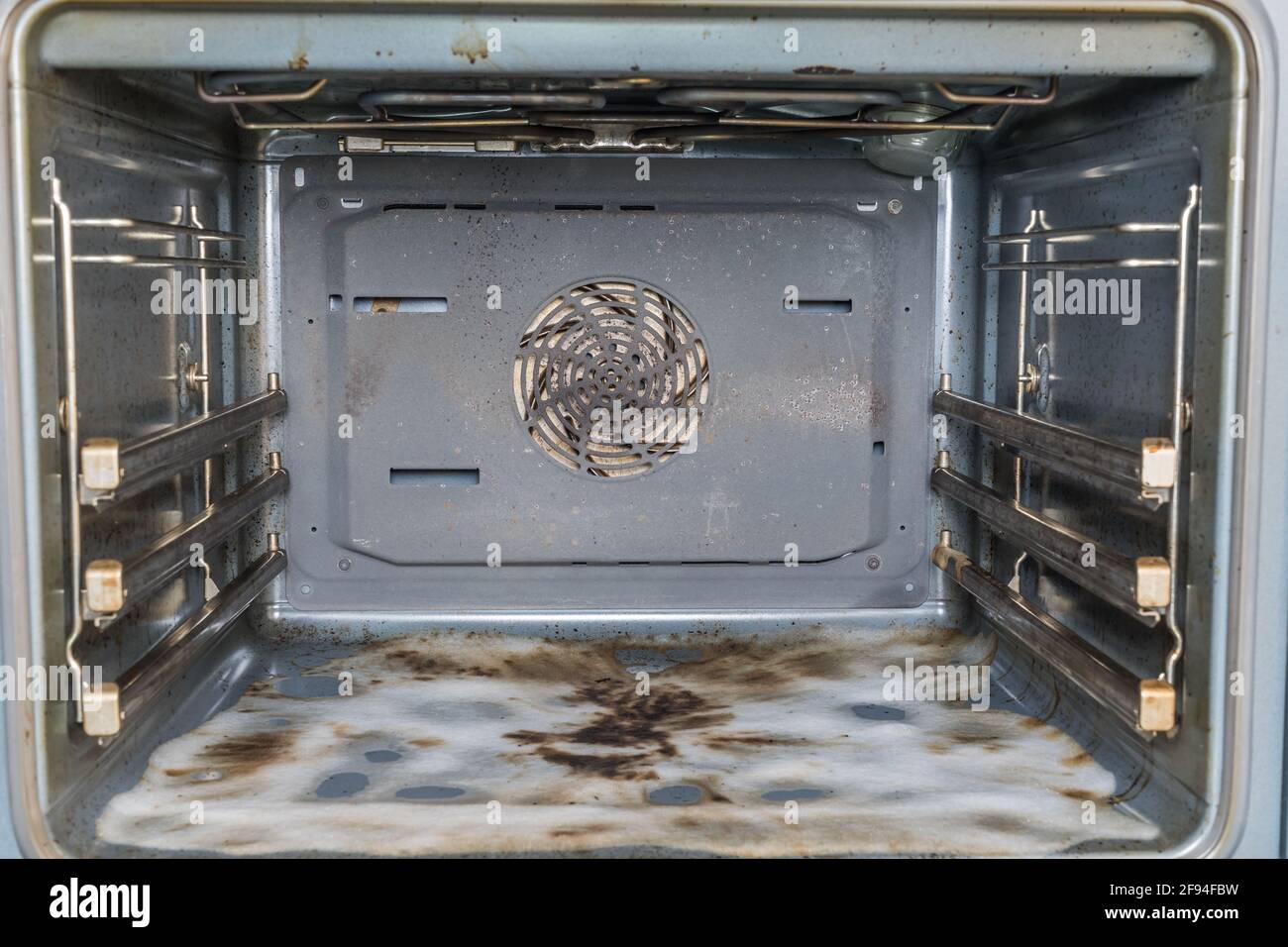 Dirty open oven, bottom covered with cleaning foam Stock Photo Alamy