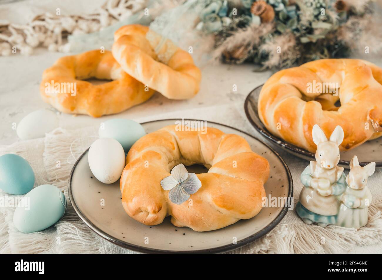 Homemade easter buns on a table decorated for easter brunch or breakfast Stock Photo