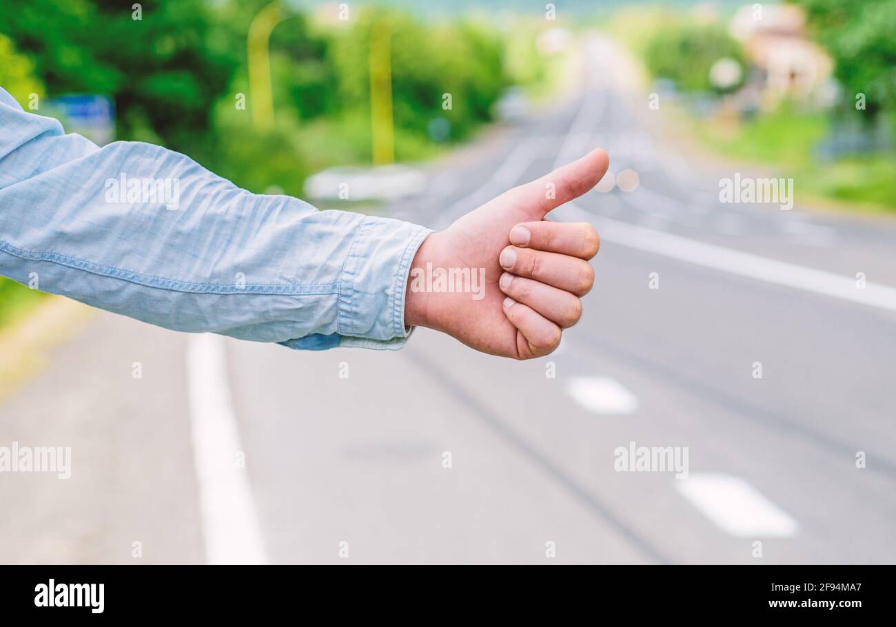 Most popular way of hitchhiking is to thumb up. Hand thumb up gesture ...
