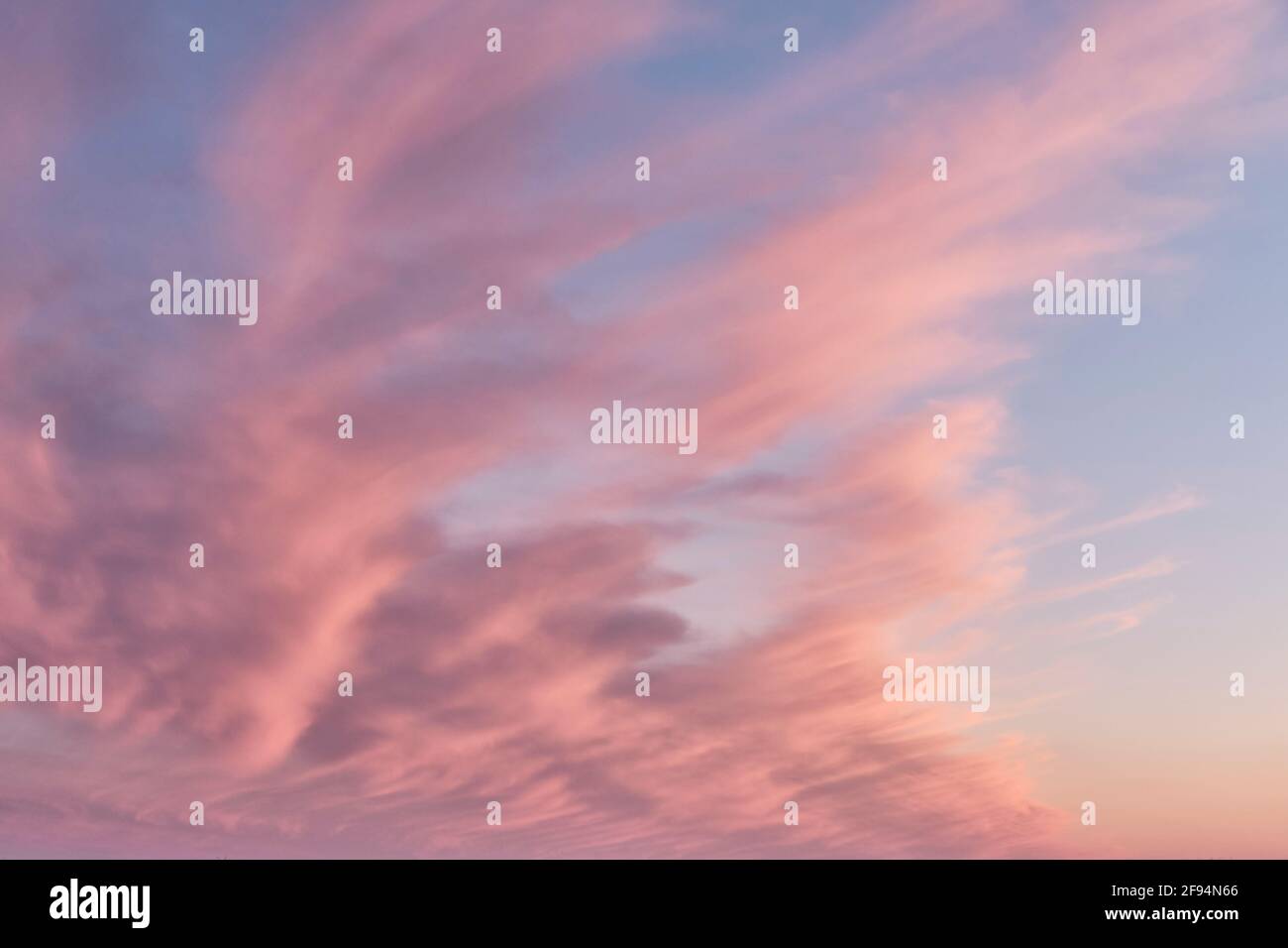 Beautiful cloudy sunset sky in pink and blue tones Stock Photo - Alamy