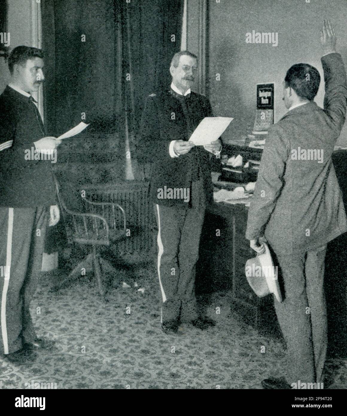 This 1903 photo shows an Army recruiting officer administering oath. Stock Photo